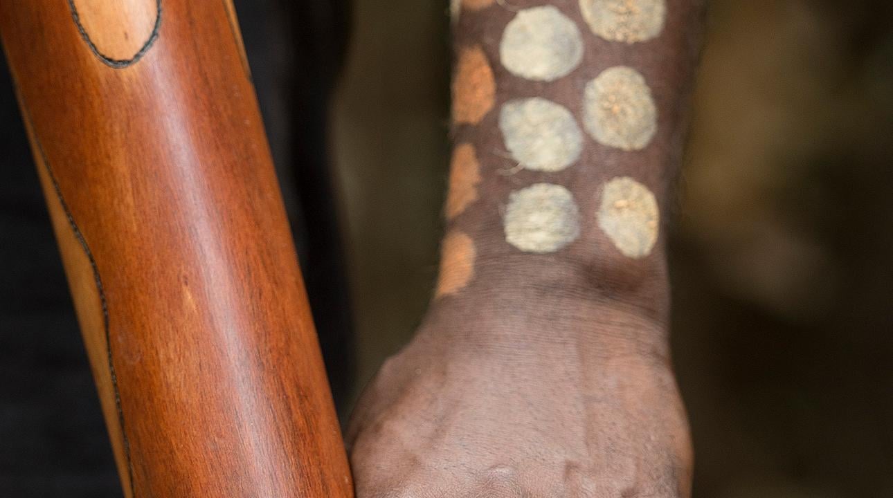 Indigenous individual with tribal painting on skin