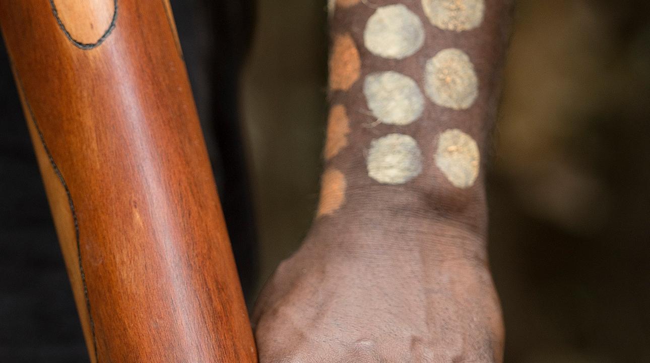 Indigenous individual with tribal painting on skin