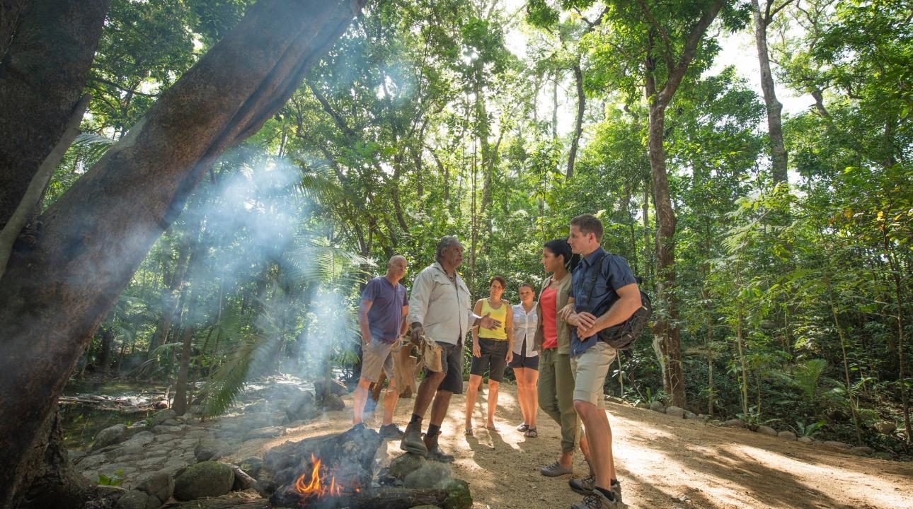 Tour guide performing a ceremony with tourists in the jungle