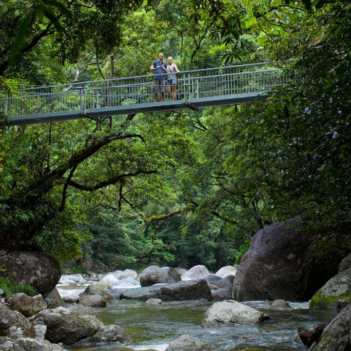 Couple standing on a bridge over a river