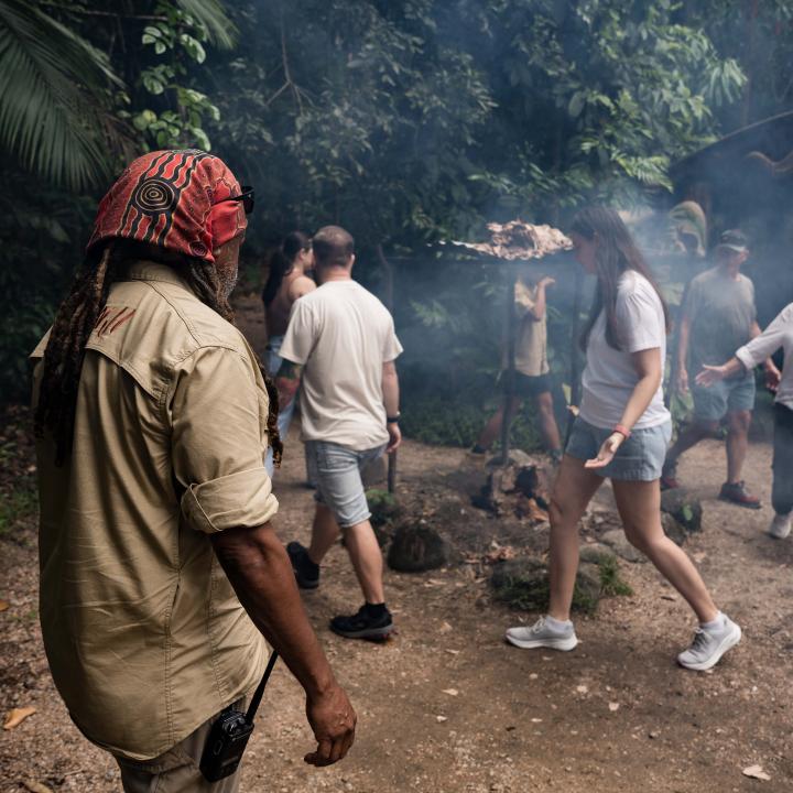 Guide and group of people walking around the smoking ceremony