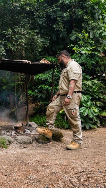 Male demonstrating smoking ceremony during the Dreamtime Walk at Mossman Gorge