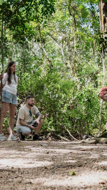 Guide demonstrating to the group on the Dreamtime Walk at Mossman Gorge