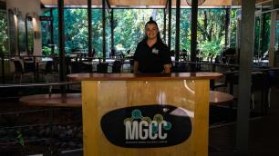 MGCC Staff member standing at MGCC desk in Mayi Cafe and Restaurant